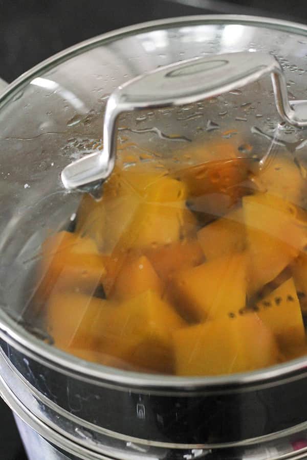 pumpkin pieces in a steamer basket.