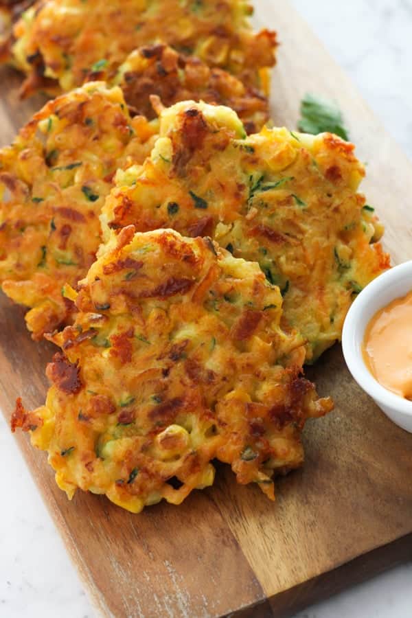 vegetable fritters on a wooden board.