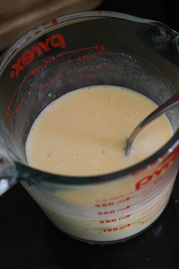 eggs whisked in a glass jug.