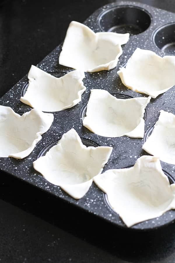 puff pastry squares divided into muffin cups.