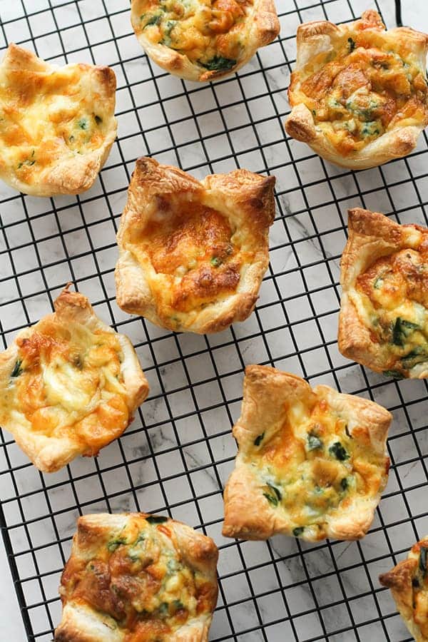 cooked mini quiches on a cooling rack.