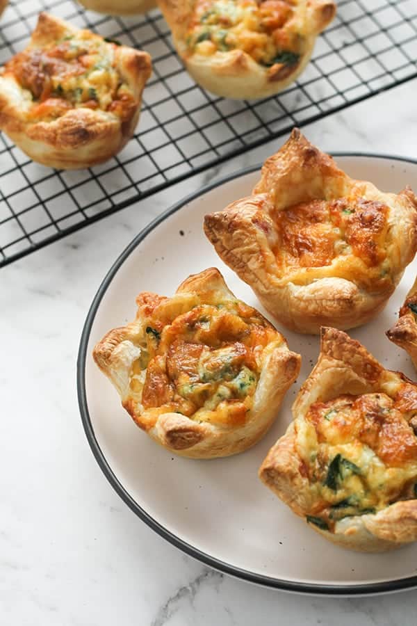 mini quiches on a white plate.