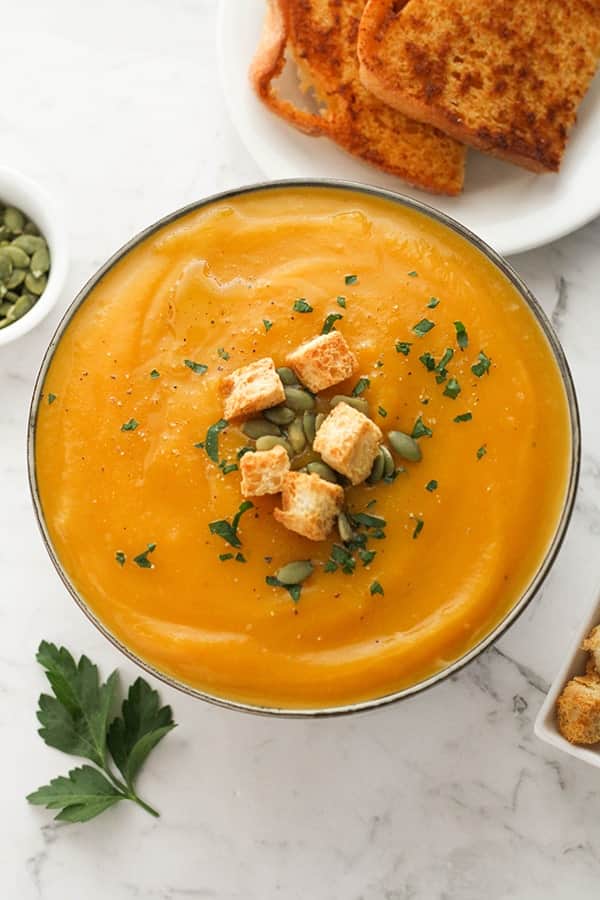 pumpkin soup topped with croutons and pumpkin seeds.