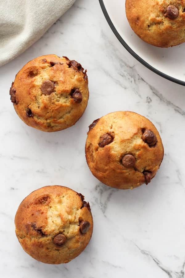 banana muffins on a marble countertop.