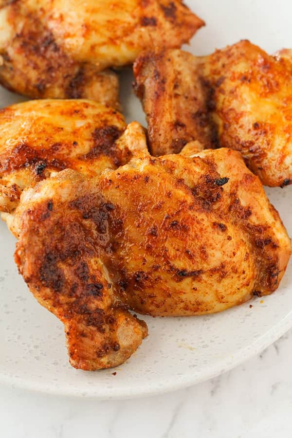 chicken thighs on a plate with parsley.