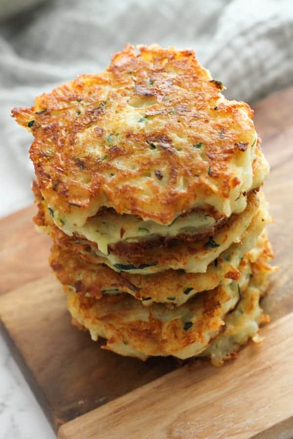 stack of potato fritters on a wooden serving bowl.