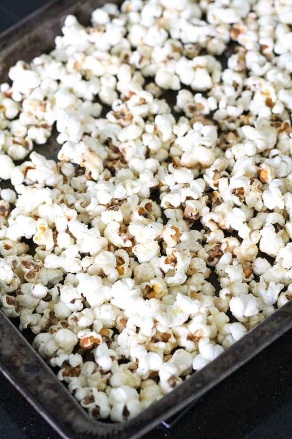 popcorn in a single layer on a baking tray.