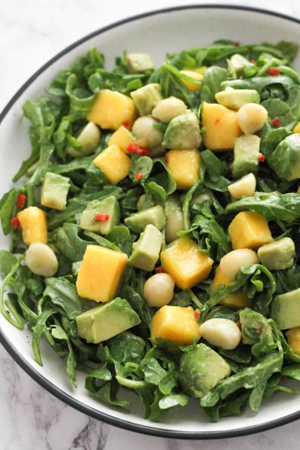 mango avocado salad in a white bowl.