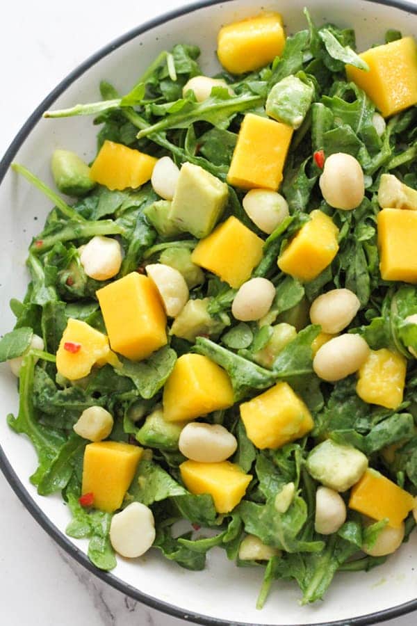 mango avocado salad in a white bowl.