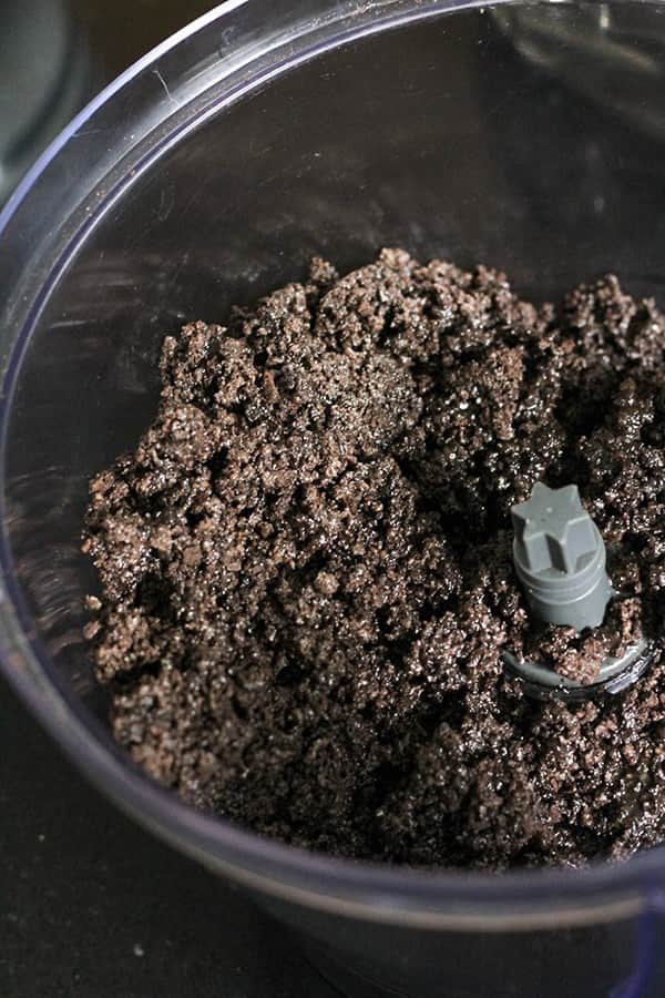 oreo crumbs mixed with butter in a bowl.