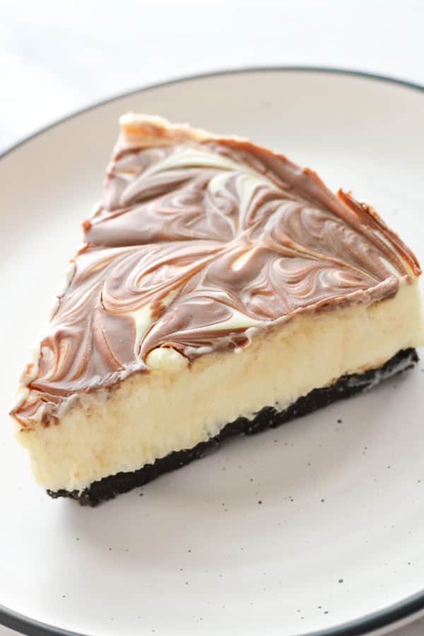 a slice of marble cheesecake on the plate.