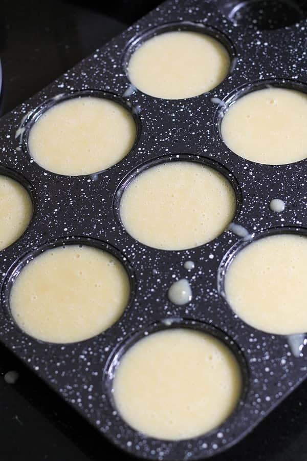 cupcake mixture spooned into muffin tray.
