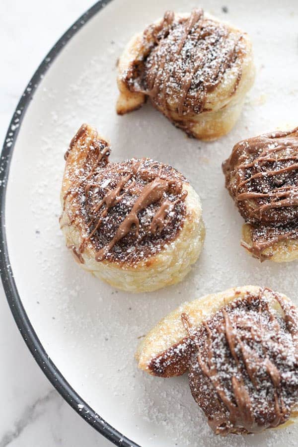 chocolate pinwheels on a white plate.