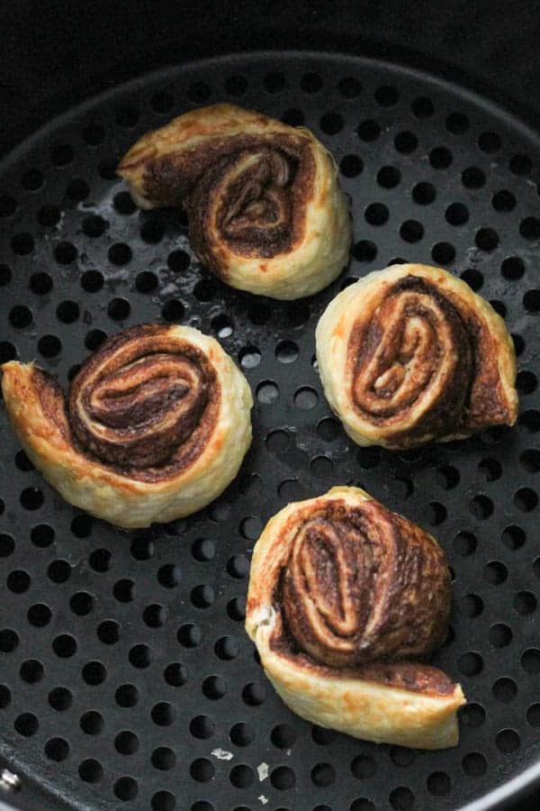 the pinwheels in an air fryer basket.