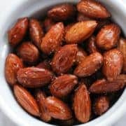 honey roasted almonds in a white bowl.
