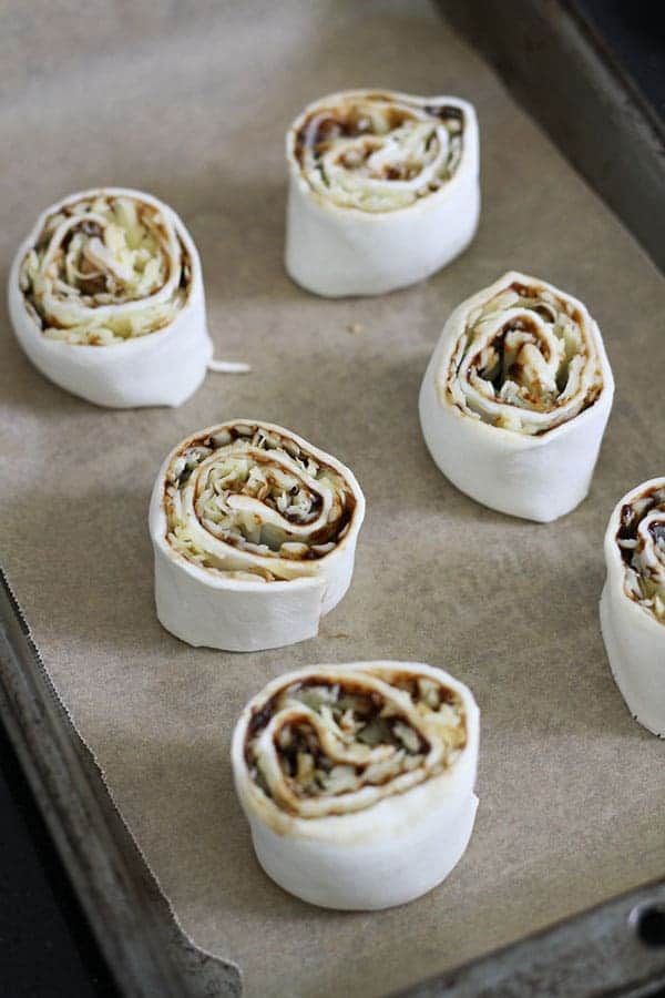 the pin wheels on a baking tray ready to be baked.