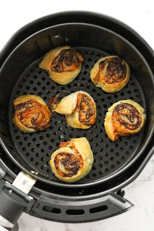 vegemite and pinwheels in an air fryer basket.