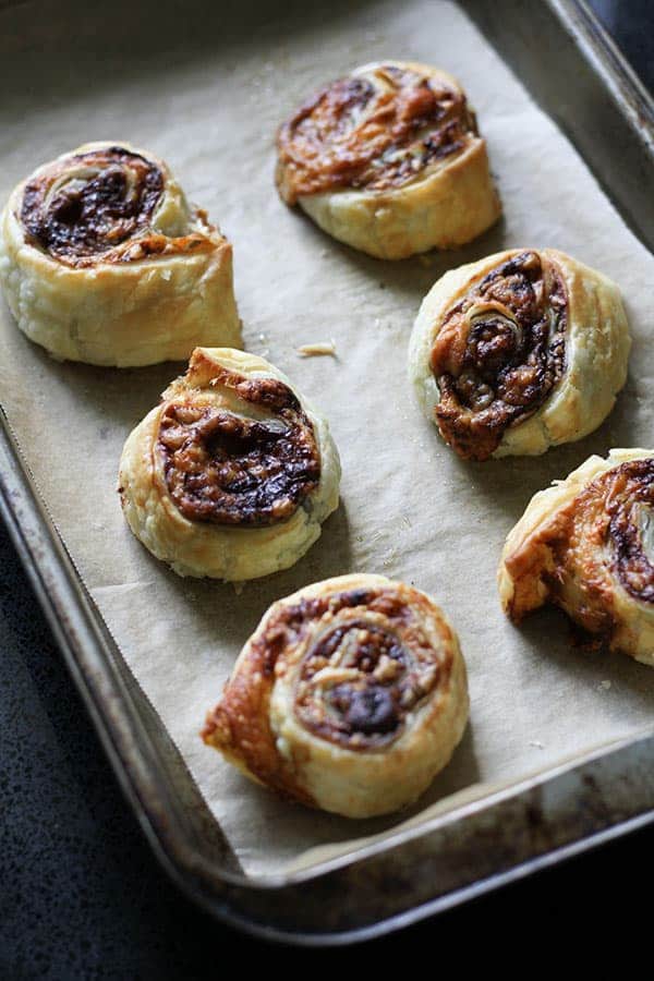 vegemite and cheese pinwheels on a baking tray.