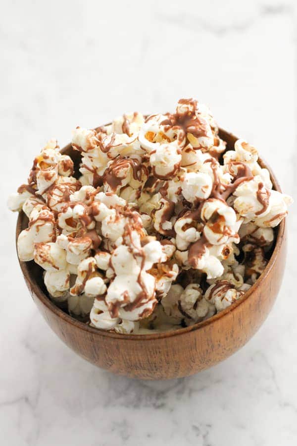 chocolate drizzled popcorn in a bowl.
