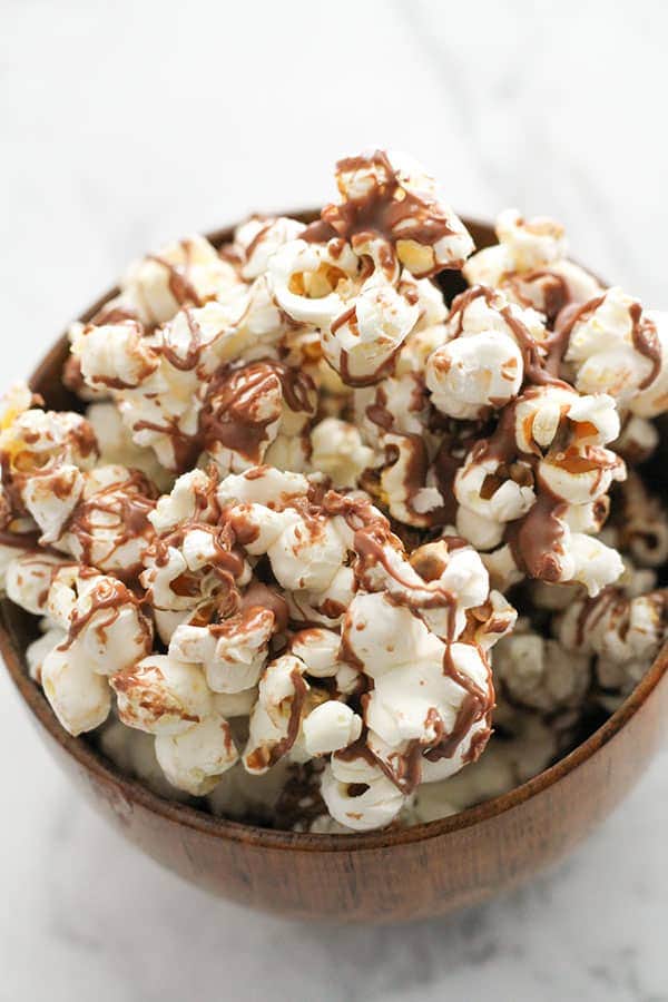 chocolate drizzled popcorn in a bowl.