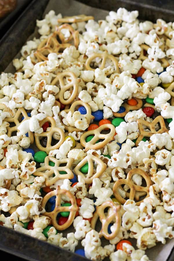 popcorn snack mix on a baking tray.