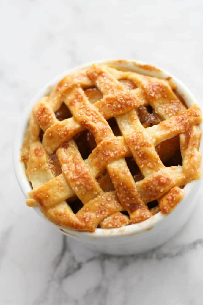 mini apple pie in a white ramekin.
