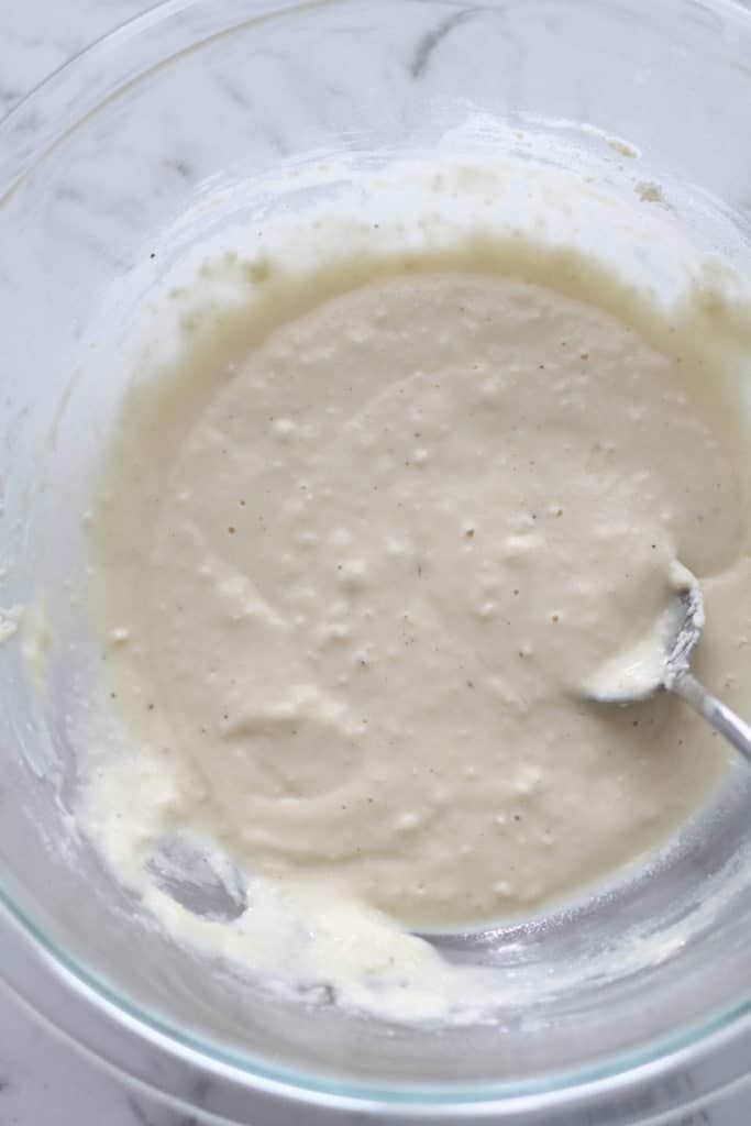 fritter batter in a glass bowl.