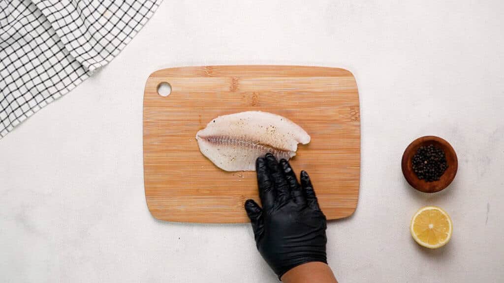 Tilapia fillet on cutting board