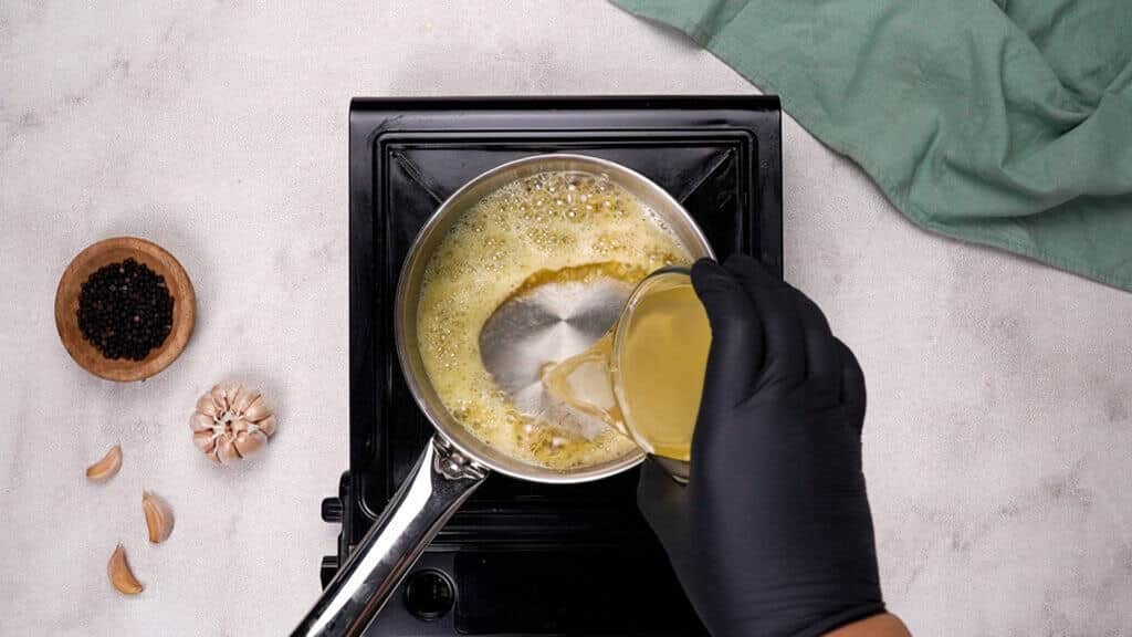 pour chicken broth into the bowl