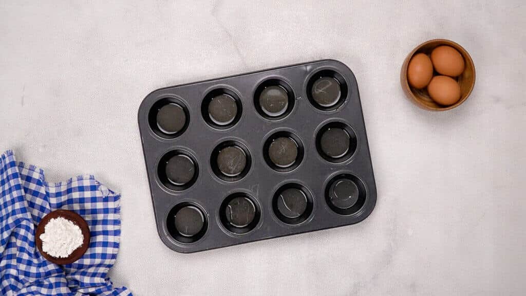 Add little fat to each muffin cup