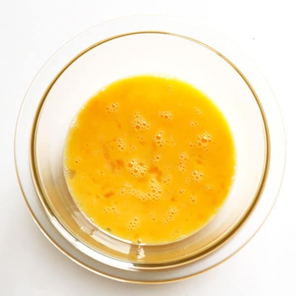 whisked eggs in a glass bowl