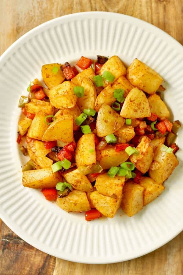 crispy breakfast potatoes on a white plate