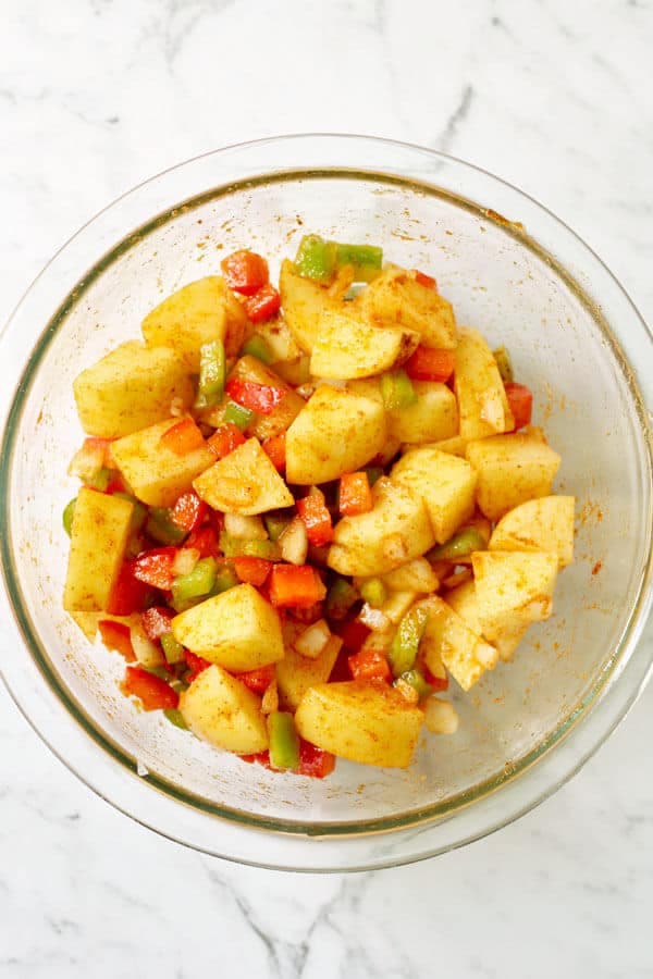 crispy breakfast potatoes ingredients in a glass bowl