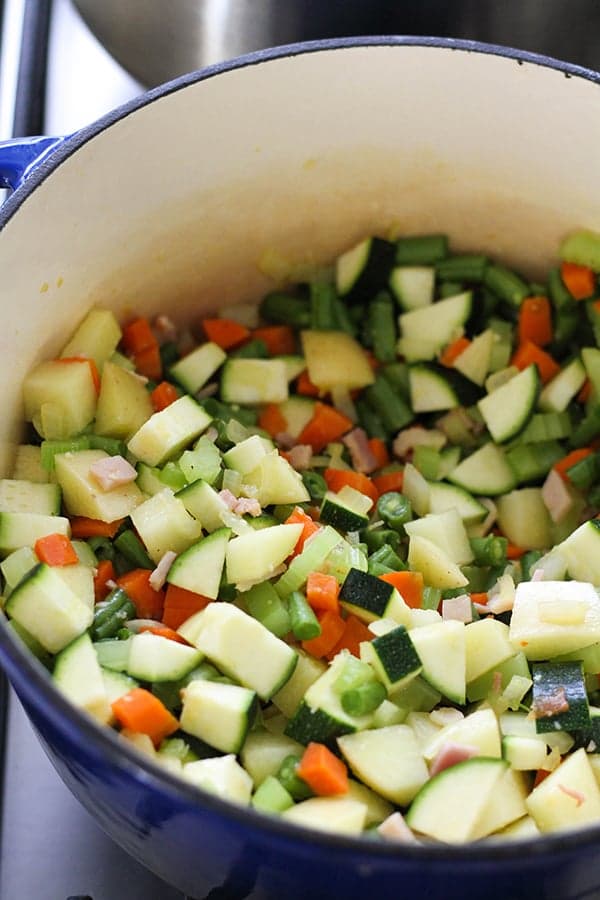 Italian Minestrone Soup ingredients in a dutch oven.
