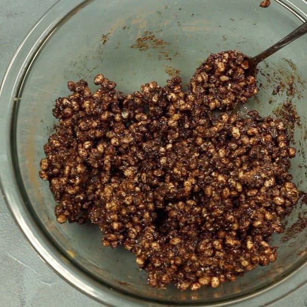 healthy chocolate crackles ingredients mixed together in a glass bowl 