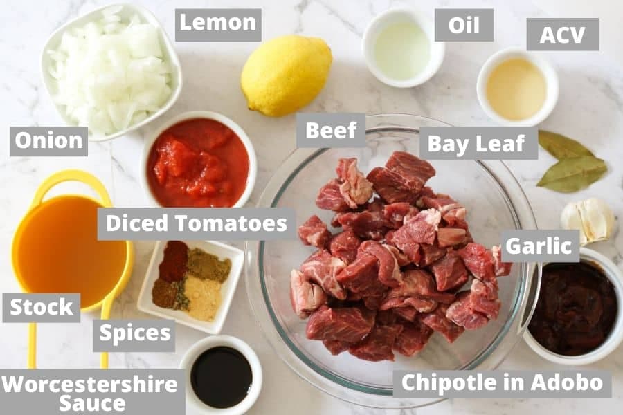 shredded mexican beef ingredients on a white marble background.