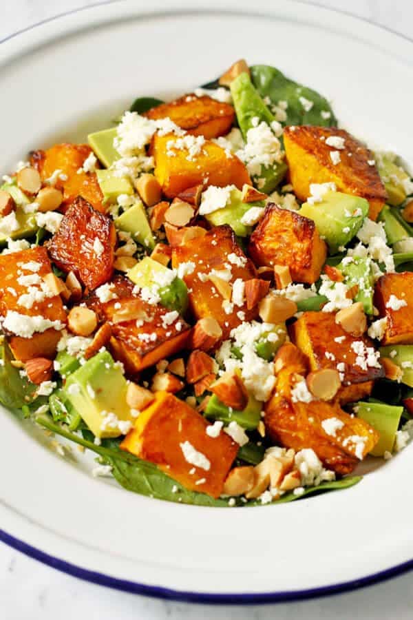 roast pumpkin, spinach and feta salad on a white plate