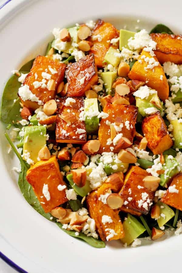 roast pumpkin, spinach and feta salad on a white plate
