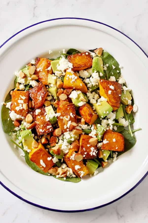 roast pumpkin, spinach and feta salad on a white plate