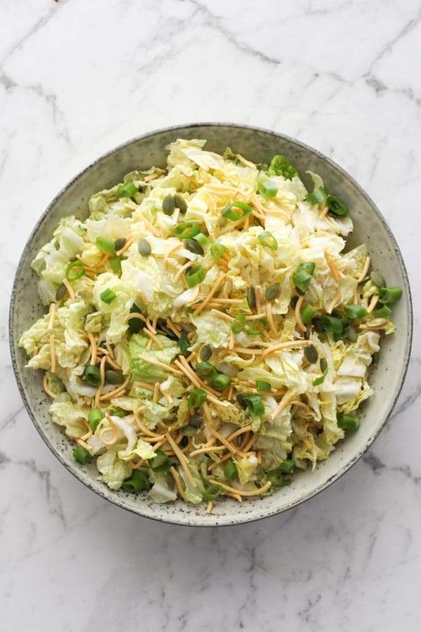 cabbage and crunchy noodle salad in a large bowl.