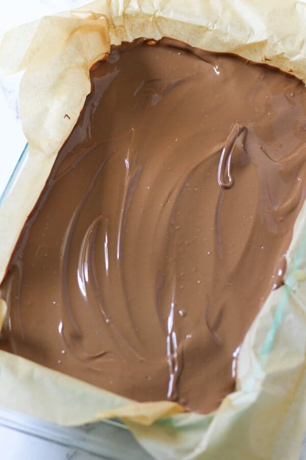 slice covered in melted chocolate ready to set in the fridge