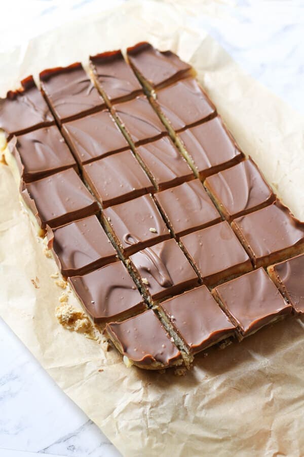 chocolate caramel slice on brown baking paper