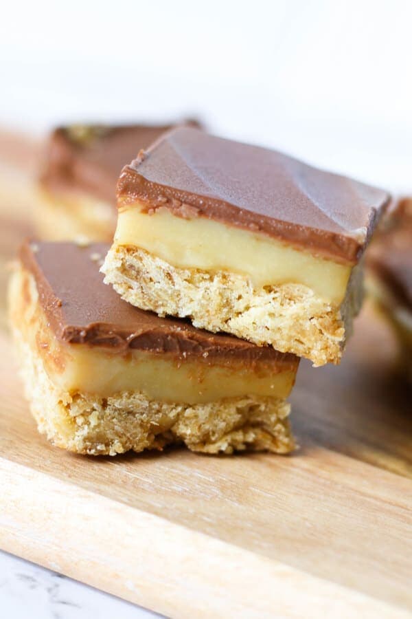 2 pieces of chocolate caramel slice stacked on top of each other