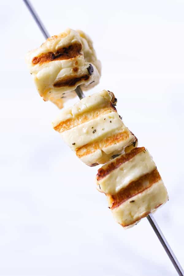 grilled halloumi cubes on a skewer.