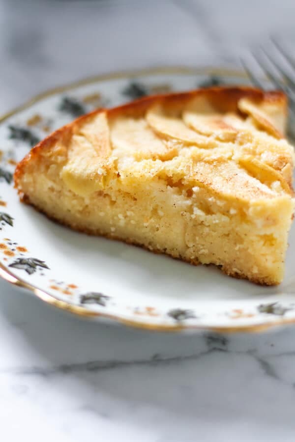 a slice of apple cake on a decorative plate.