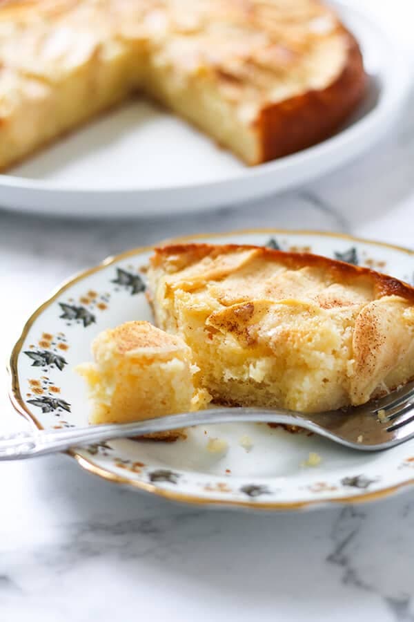 a slice of apple cake on a decorative plate.