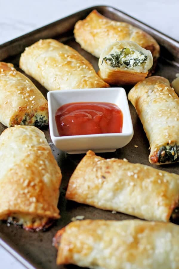 spinach and ricotta rolls on a baking tray.