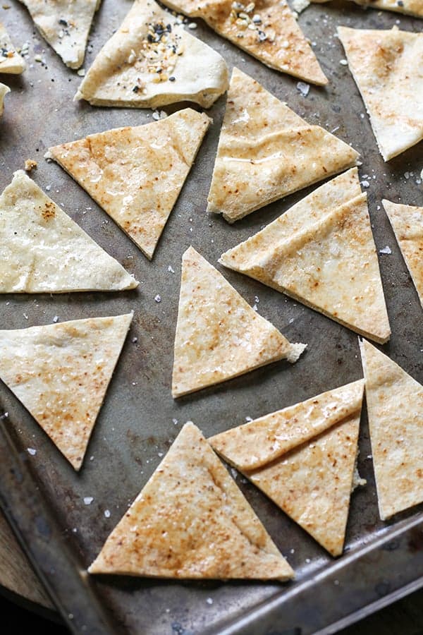 pita triangles on a baking tray ready to be baked.
