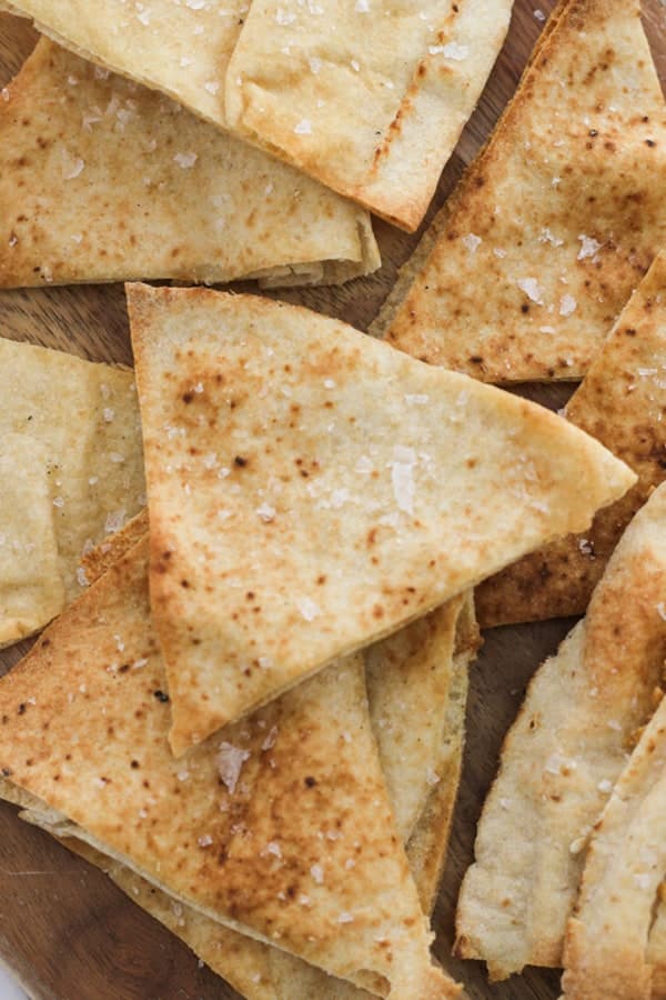 baked pita chips stacked on top of each other.