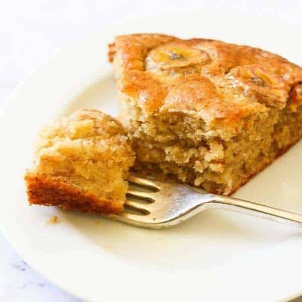 a slice of banana cake on a white plate.